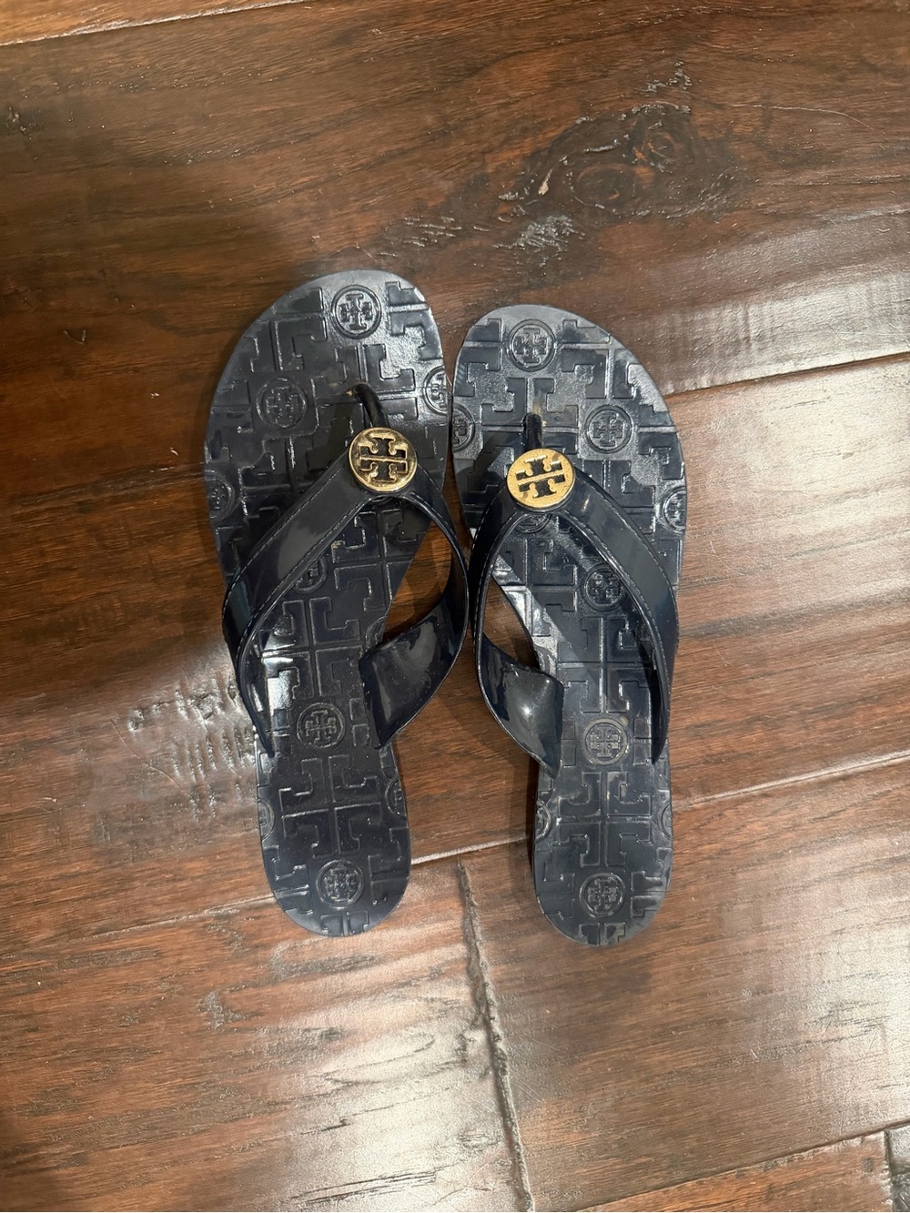 Tory Burch Black Jelly Flip Flops with Gold Logo Medallion